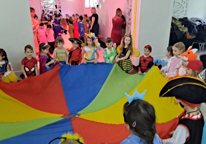 Dzieci uczestniczą w zabawie z wykorzystaniem chusty animacyjnej