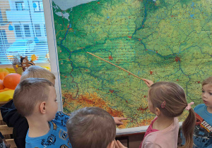 Weronika wskazuje na mapie Polski płynące rzeki