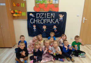 Dzieci pozują do zdjęcia na tle dekoracji.