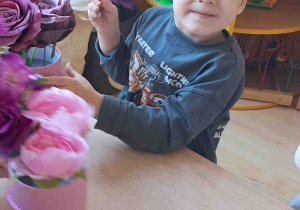 Dzieci samodzielnie tworzą kompozycje ze sztucznych kwiatów