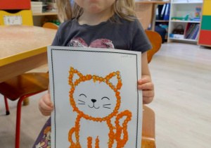 Dziewczynka trzyma pracę kota.