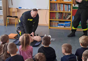 Strażacy demonstrują na fantomie udzielanie pomocy poszkodowanemu