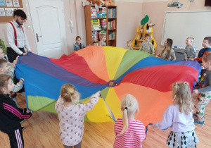 Dzieci bawią się wspólnie z kolorową chustą animacyjną