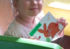Dziewczynka prezentuje swoją kartkę wielkanocną