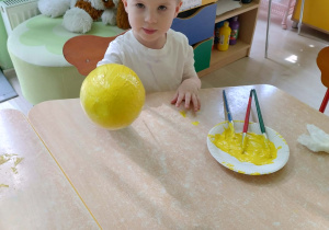 Chłopiec koloruje styropianowe jajko