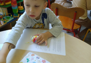 Chłopiec maluje pisanke