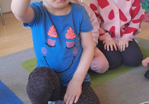 Dziecko pokazuje co należy włożyć do koszyczka wielkanocnego