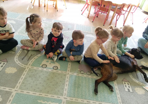 Dziewczynki głaskają psa