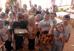 Dzieci pozują do zdjęcia z upieczonym ciastem