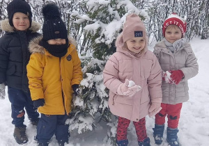 dzieci bawią się w ogrodzie przedszkolnym na śniegu